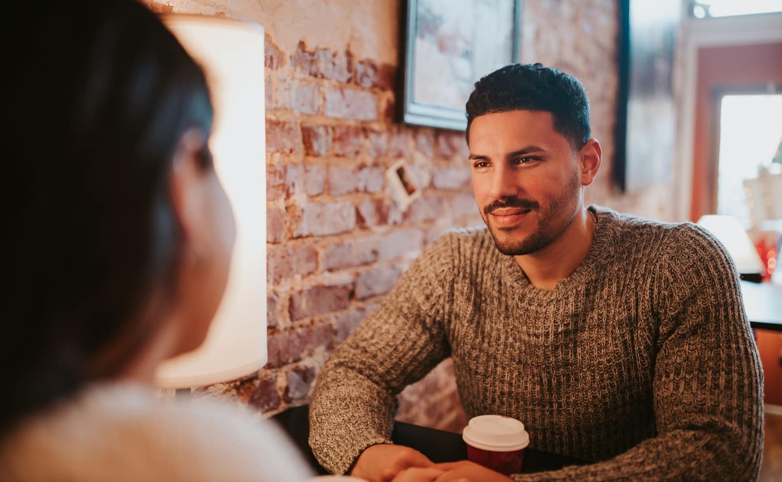 A couple relaxes over coffee while their everyday details are coordinated by Cellular Concierge.